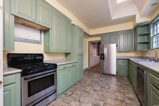 111 Thayer St, Little Rock, AR 72205 - kitchen featuring stainless steel appliances, green cabinets, a sink, light countertops, and stone finish flooring