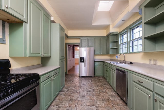 111 Thayer St, Little Rock, AR 72205 - kitchen featuring appliances with stainless steel finishes, green cabinetry, open shelves, and a sink