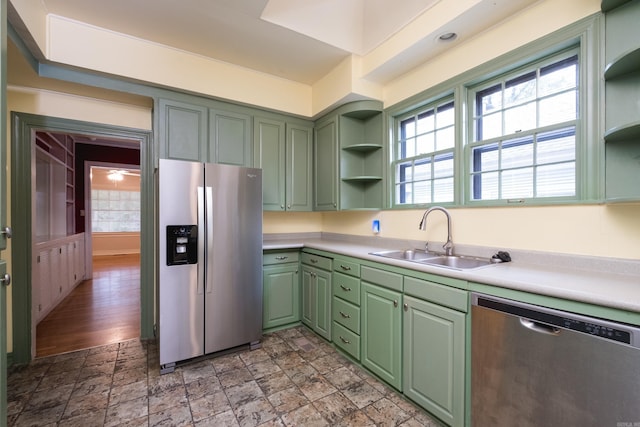 111 Thayer St, Little Rock, AR 72205 - kitchen with appliances with stainless steel finishes, green cabinetry, open shelves, a sink, and light countertops