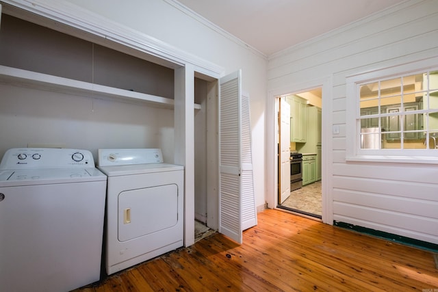 111 Thayer St, Little Rock, AR 72205 - laundry room with ornamental molding, washing machine and dryer, and light wood-type flooring