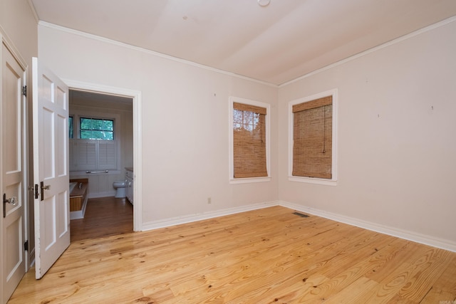 111 Thayer St, Little Rock, AR 72205 - empty room featuring crown molding, light wood-style flooring, and baseboards