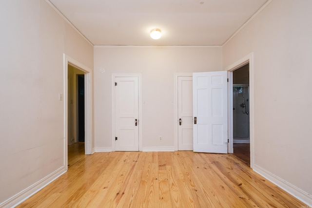 111 Thayer St, Little Rock, AR 72205 - unfurnished bedroom featuring crown molding, light wood-style floors, and baseboards