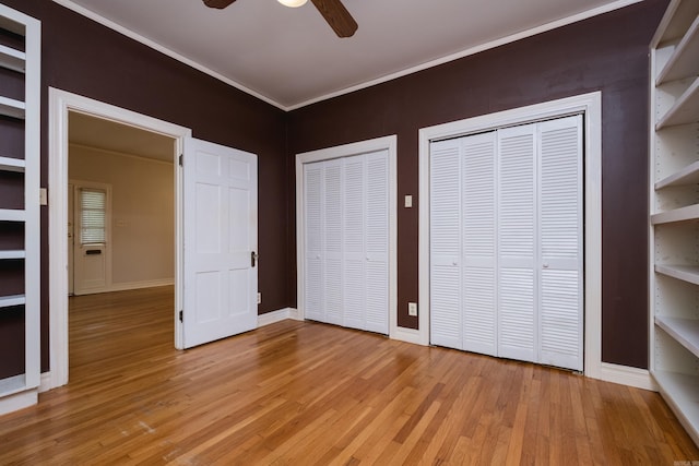 111 Thayer St, Little Rock, AR 72205 - unfurnished bedroom featuring multiple closets, light wood-style floors, crown molding, baseboards, and ceiling fan