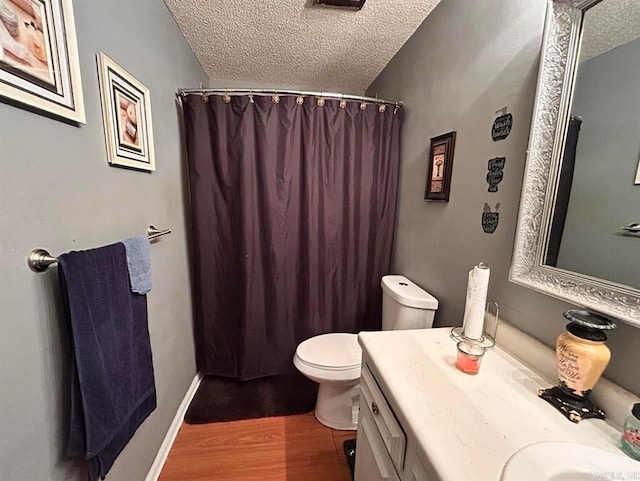 9314 Timber Valley Rd, Little Rock, AR 72204 - full bath featuring a textured ceiling, wood finished floors, toilet, vanity, and curtained shower