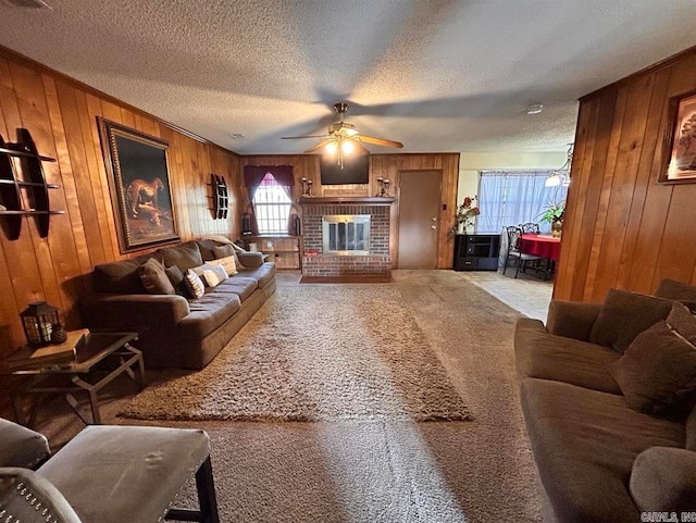 9314 Timber Valley Rd, Little Rock, AR 72204 - carpeted living area featuring wood walls, a ceiling fan, a textured ceiling, and a fireplace