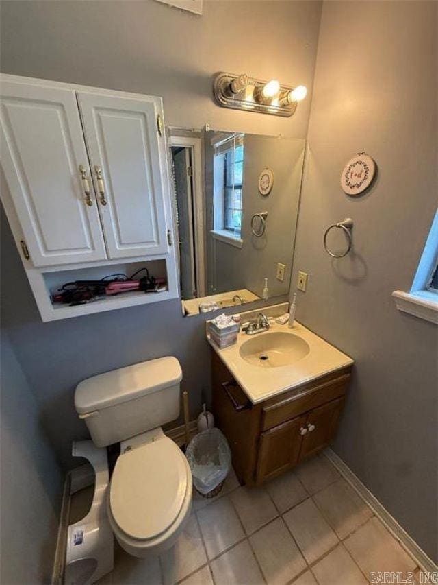 809 Walnut St, Dardanelle, AR 72834 - bathroom with tile patterned floors, toilet, vanity, and baseboards