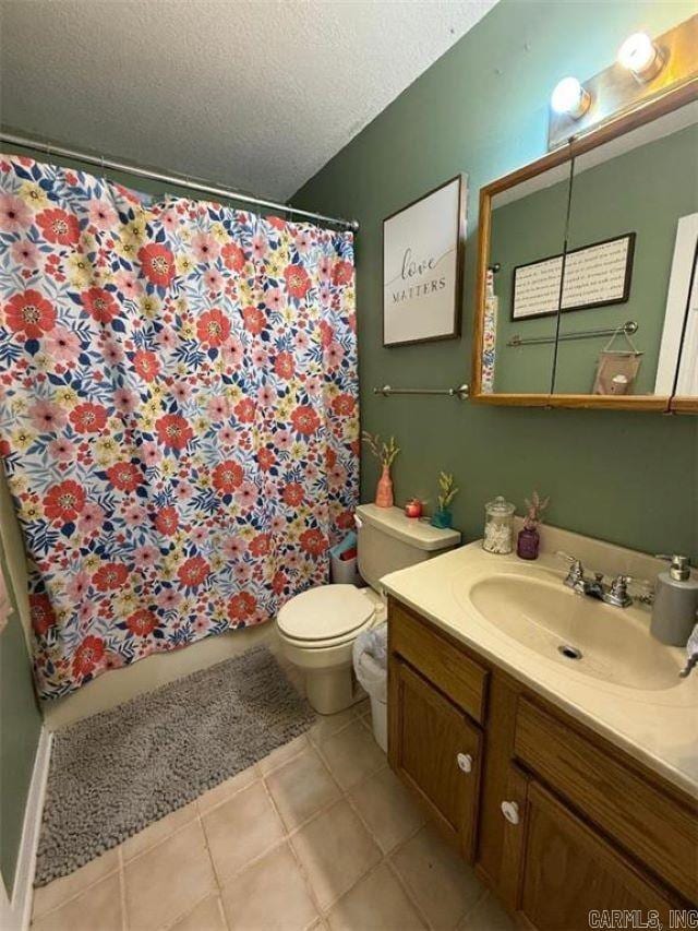 809 Walnut St, Dardanelle, AR 72834 - bathroom featuring a textured ceiling, vanity, toilet, tile patterned floors, and a shower with shower curtain