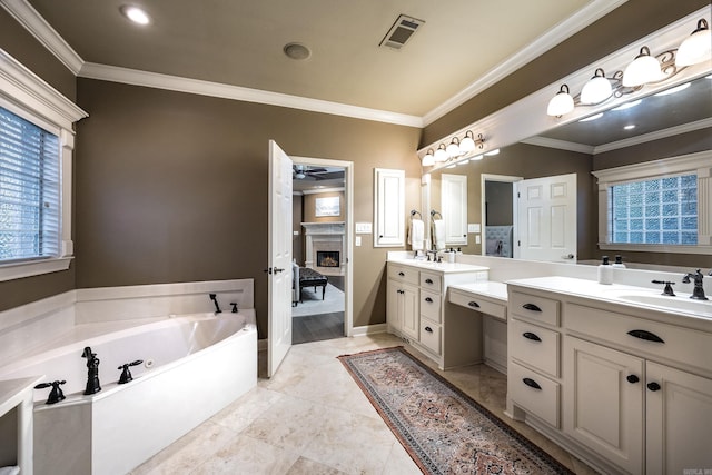 126 Manitou Dr, Maumelle, AR 72113 - ensuite bathroom with a fireplace, crown molding, a bath, two vanities, and recessed lighting