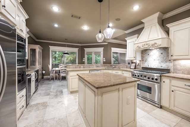 126 Manitou Dr, Maumelle, AR 72113 - kitchen featuring appliances with stainless steel finishes, a sink, premium range hood, a peninsula, and decorative backsplash