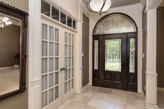 126 Manitou Dr, Maumelle, AR 72113 - foyer with french doors, crown molding, baseboards, a chandelier, and ornate columns