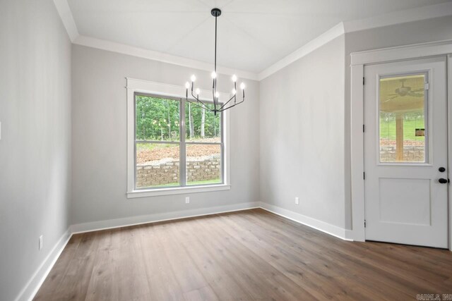 9313 Wooddale Dr, Sherwood, AR 72120 - unfurnished dining area featuring crown molding, a chandelier, wood finished floors, and baseboards