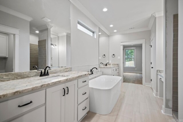 9313 Wooddale Dr, Sherwood, AR 72120 - full bath featuring two vanities, a freestanding bath, recessed lighting, baseboards, and crown molding