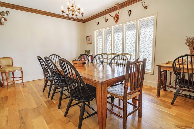 2005 Kingshighway, Weiner, AR 72479 - dining space featuring a chandelier, crown molding, baseboards, and light wood-type flooring