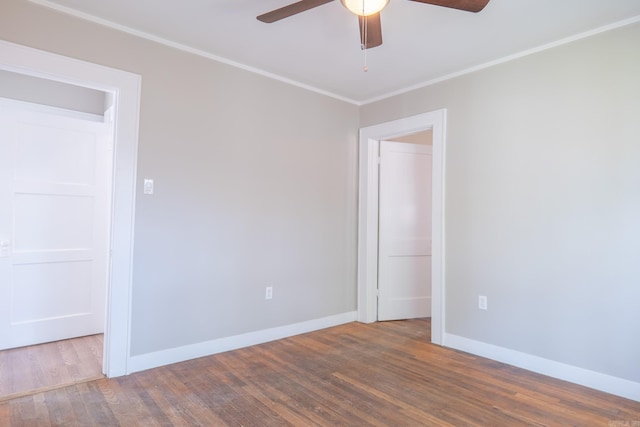 unfurnished room with ceiling fan, wood finished floors, baseboards, and ornamental molding