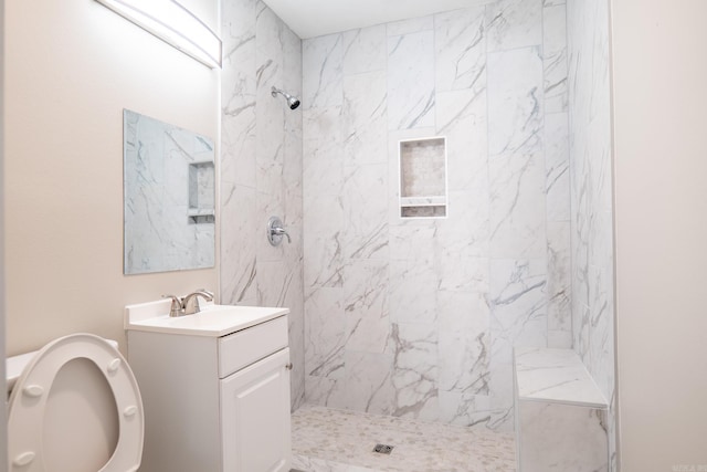 full bathroom featuring a marble finish shower, vanity, and toilet