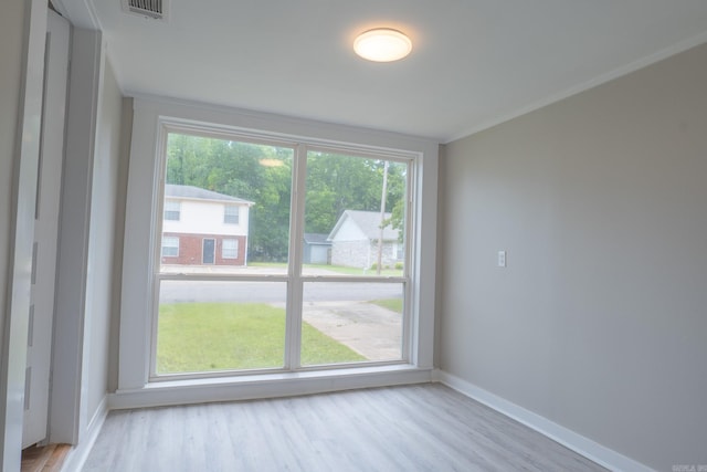 spare room featuring baseboards and light wood-style flooring