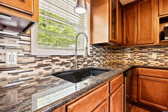 821 Mcadoo St, Little Rock, AR 72205 - kitchen with a sink, decorative backsplash, dark stone countertops, brown cabinetry, and extractor fan