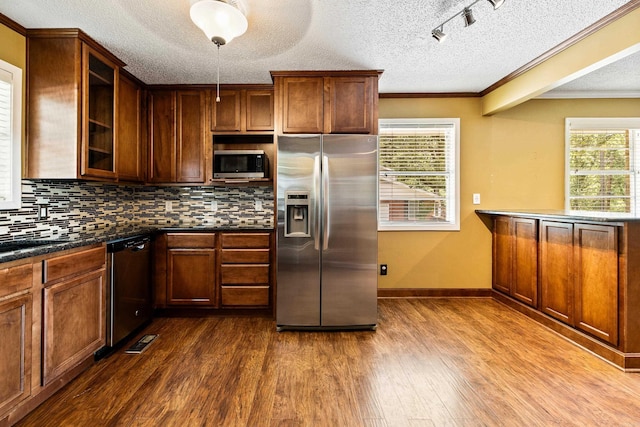 821 Mcadoo St, Little Rock, AR 72205 - kitchen with appliances with stainless steel finishes, a textured ceiling, dark wood-style flooring, ornamental molding, and tasteful backsplash