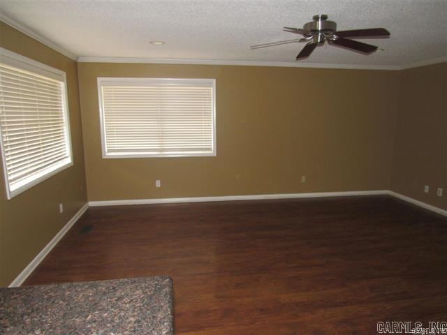 821 Mcadoo St, Little Rock, AR 72205 - empty room with wood finished floors, ornamental molding, ceiling fan, baseboards, and a textured ceiling