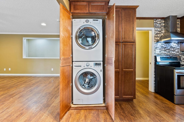 821 Mcadoo St, Little Rock, AR 72205 - washroom with stacked washer and clothes dryer, a textured ceiling, wood finished floors, ornamental molding, and baseboards