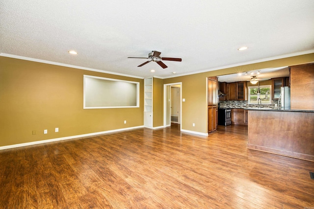 821 Mcadoo St, Little Rock, AR 72205 - unfurnished living room featuring a ceiling fan, wood finished floors, crown molding, baseboards, and a sink