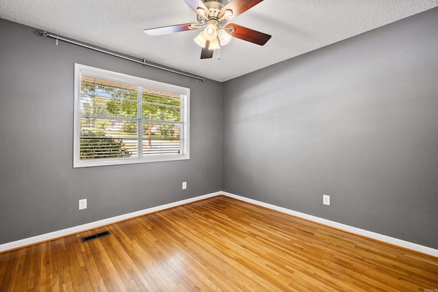 821 Mcadoo St, Little Rock, AR 72205 - spare room with wood-type flooring, baseboards, ceiling fan, and a textured ceiling