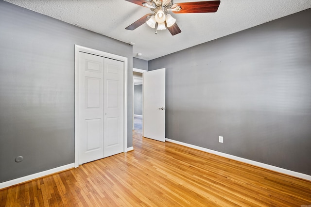 821 Mcadoo St, Little Rock, AR 72205 - unfurnished bedroom with light wood-type flooring, baseboards, a closet, a ceiling fan, and a textured ceiling