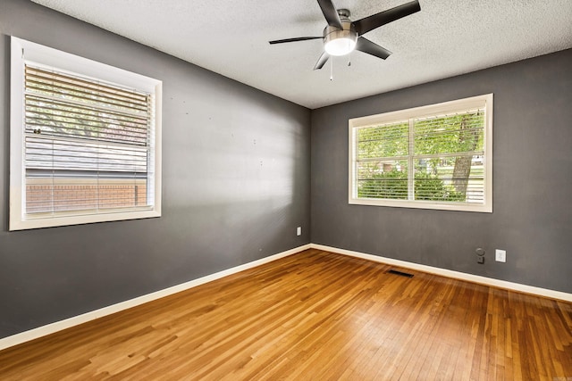 821 Mcadoo St, Little Rock, AR 72205 - empty room with hardwood / wood-style floors, ceiling fan, baseboards, and a textured ceiling