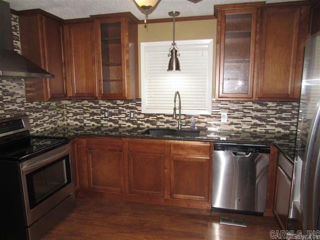 821 Mcadoo St, Little Rock, AR 72205 - kitchen with appliances with stainless steel finishes, wall chimney exhaust hood, a sink, and decorative backsplash