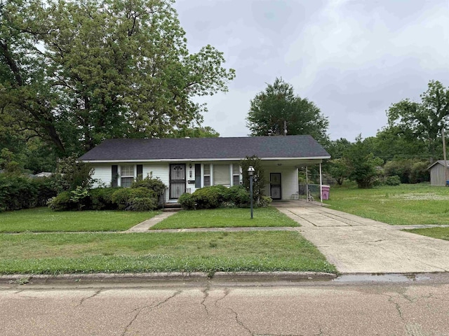 ranch-style house featuring driveway, a front yard, and an attached carport