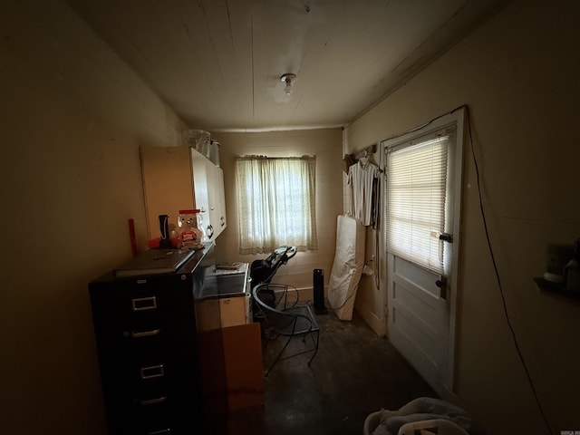 office area with unfinished concrete floors