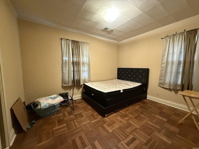 bedroom with baseboards and crown molding