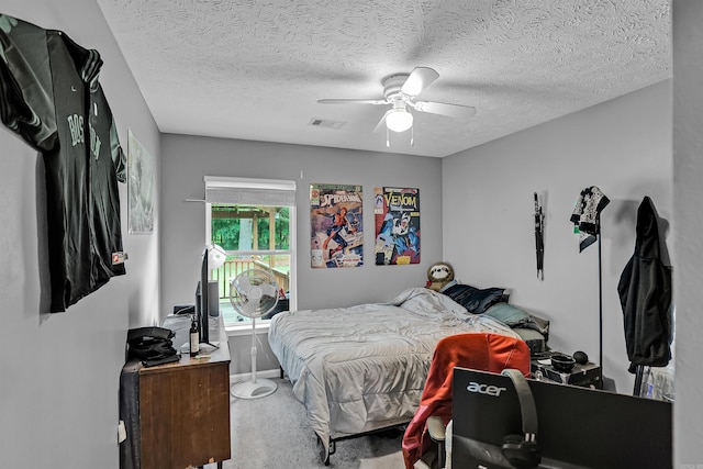 bedroom with carpet, a ceiling fan, and a textured ceiling