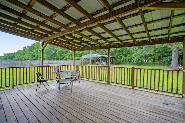 deck with outdoor dining space and a gazebo