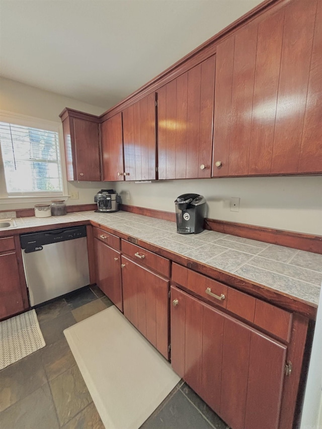 kitchen with stainless steel dishwasher and tile counters