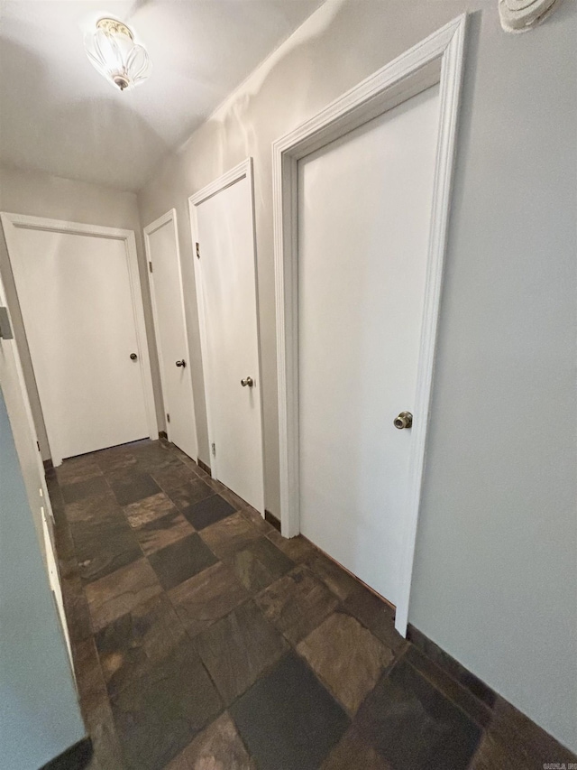 hallway featuring stone finish floors