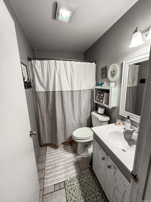 full bathroom with toilet, vanity, curtained shower, and tile patterned floors