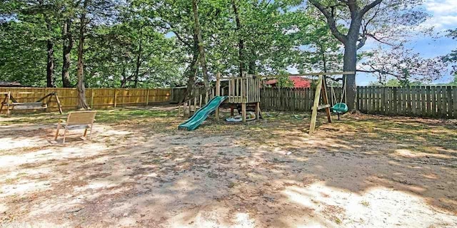 view of playground featuring a fenced backyard