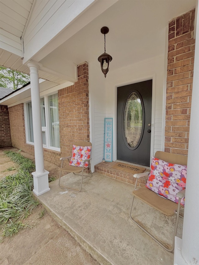 view of exterior entry with brick siding