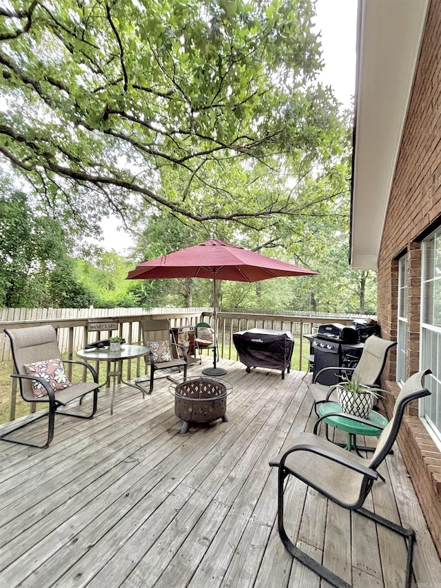 wooden deck featuring a fire pit
