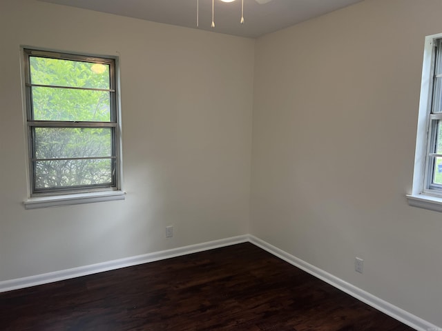 1302 Collins Dr, Pine Bluff, AR 71601 - empty room with baseboards, dark wood-style floors, and a ceiling fan