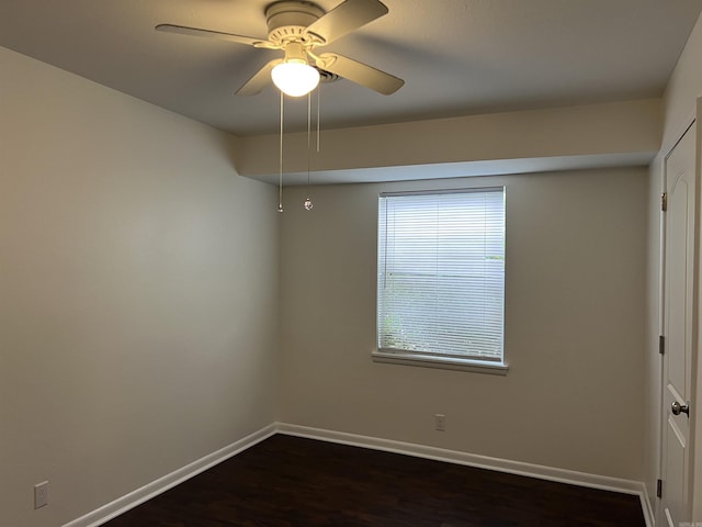 1302 Collins Dr, Pine Bluff, AR 71601 - empty room featuring baseboards, dark wood finished floors, and a ceiling fan