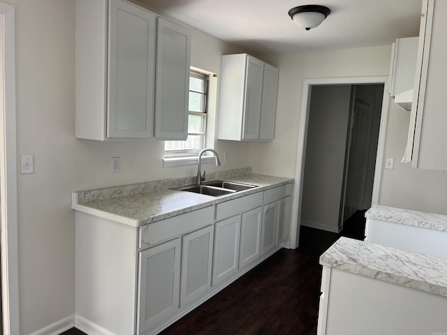 1302 Collins Dr, Pine Bluff, AR 71601 - kitchen featuring a sink, dark wood-style flooring, light countertops, and white cabinetry