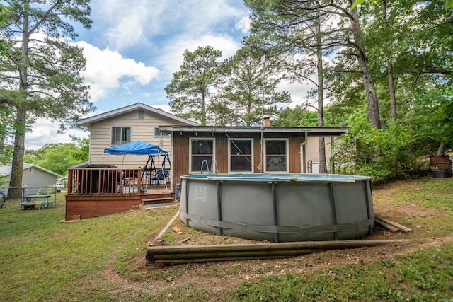 106 Gareth Ct, Hot Springs National Park, AR 71913 - rear view of house with a deck, an outdoor pool, and a chimney