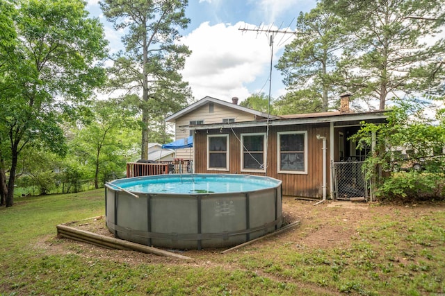 106 Gareth Ct, Hot Springs National Park, AR 71913 - rear view of house with a chimney, an outdoor pool, and a yard