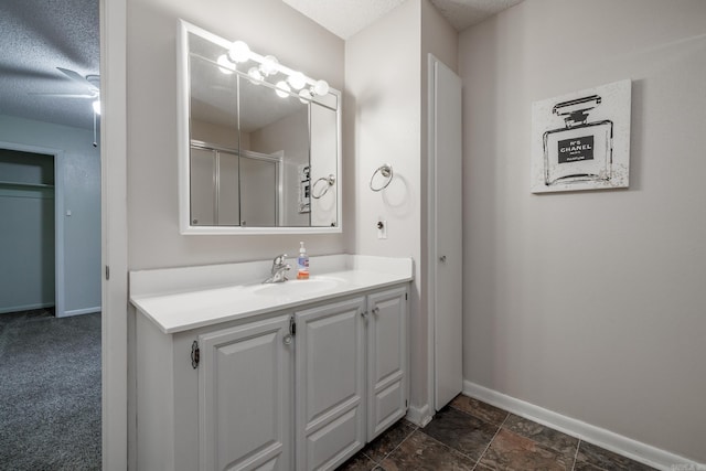 26 Destino Way, Hot Springs Village, AR 71909 - bathroom featuring vanity, baseboards, a shower with shower door, and a textured ceiling