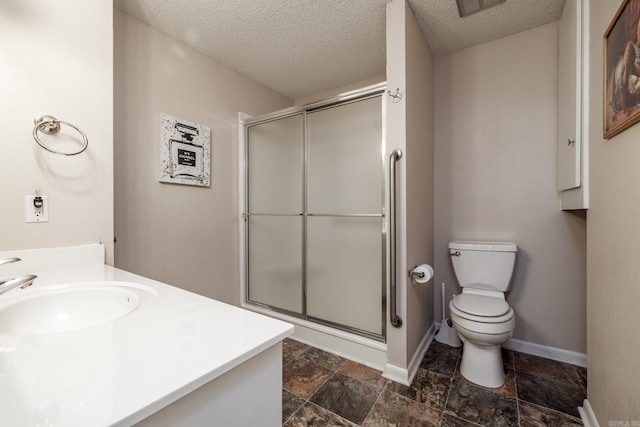 26 Destino Way, Hot Springs Village, AR 71909 - bathroom with a shower stall, toilet, stone finish floors, a textured ceiling, and baseboards