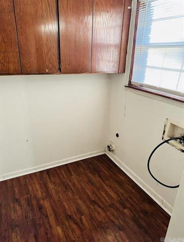 clothes washing area featuring cabinet space, baseboards, hookup for a washing machine, and dark wood-style flooring