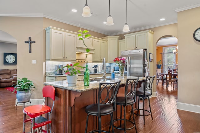 253 High Meadow Loop, Hot Springs, AR 71901 - kitchen with arched walkways, stainless steel fridge with ice dispenser, baseboards, decorative backsplash, and light stone countertops