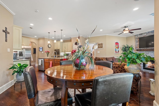 253 High Meadow Loop, Hot Springs, AR 71901 - dining area with ceiling fan, dark wood finished floors, a fireplace, recessed lighting, and arched walkways